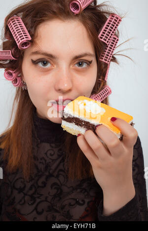 Young hungry woman with pie Stock Photo