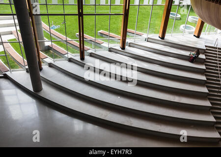 Female student sitting alone in the new student union building at UBC in Vancouver Stock Photo