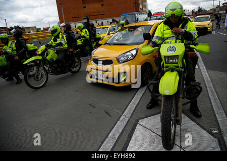 Bogota, Colombia. 29th July, 2015. Police patrols during a protest of taxi drivers against the transport service through the Uber app in Bogota, Colombia, on July 29, 2015. With the protest, taxi drivers demand the Government to forbid definitely providing taxi service to private vehicles, and to penalize taxis that provide the service through the Uber app, considered illegal some months ago. Credit:  Mauricio Alvarado/COLPRENSA/Xinhua/Alamy Live News Stock Photo