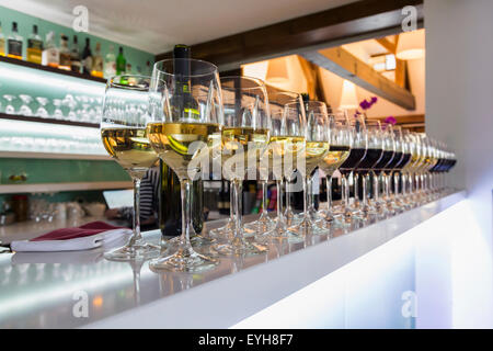 Lots of wine glasses on the bar. Stock Photo