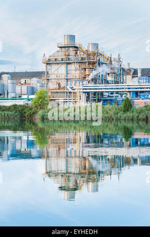 Old paper factory that is reflected in the river Stock Photo