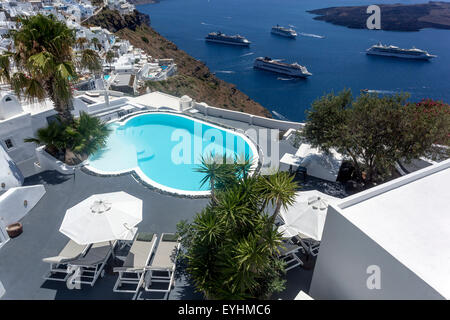 View from Imerovigli with swimming pool, Cruises, Santorini Cruise Ships moored in the caldera, Greek Islands Sea bay Cyclades, Greece pool top view Stock Photo