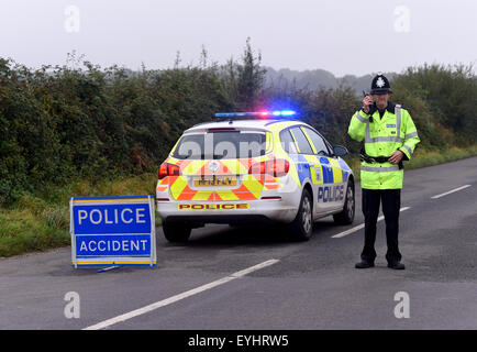 Police at a road closed road traffic collision incident, Policeman closed road, UK Stock Photo