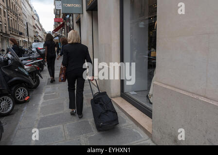 Paris, France, Woman walking away, on Street in front of  Luxury Clothes Shop, Rue Faubourg Saint Honoré, Tom Ford Sign Stock Photo