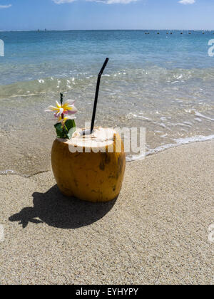 Flic en Flac, Mauritius. La Pirogue tourist resort. Coconut cocktail on the beach. Stock Photo