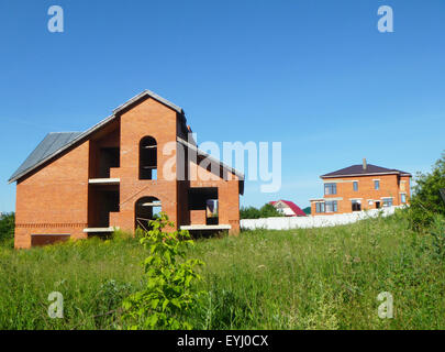 Construction of the new cottages from red brick Stock Photo
