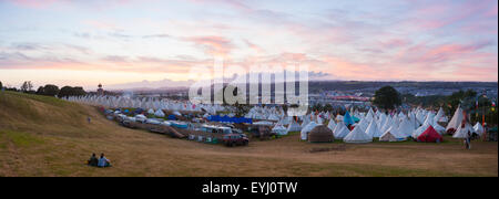 GLASTONBURY, UK - JUNE 26, 2015 : Panoramic view of the Glastonbury Festival site at sunset from the King's Meadow Stock Photo