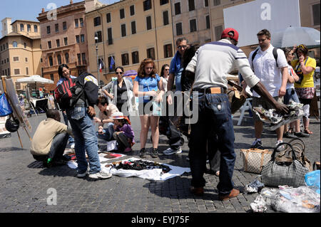 Italy, Rome, Piazza Navona, immigrants selling counterfeit goods to tourists Stock Photo