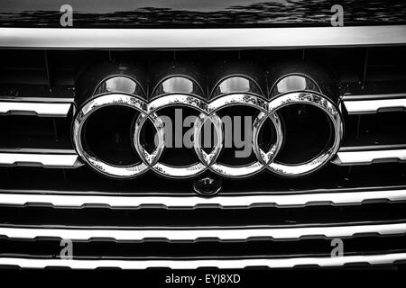 The emblem on the front grille of a full-size luxury crossover SUV Audi Q7 3.0 TDI quattro. Stock Photo