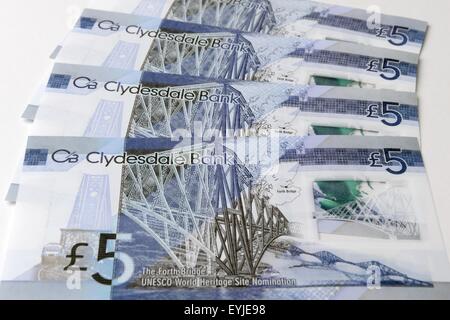 Clydesdale bank plastic £5 notes showing the newly designated world heritage Forth rail bridge in Scotland, UK Stock Photo