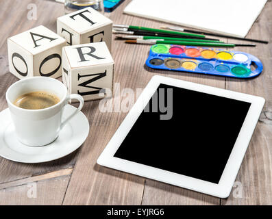 Artistic workplace mock up with black coffee. Watercolor, brushes, tablet pc, painting tools and accessories Stock Photo