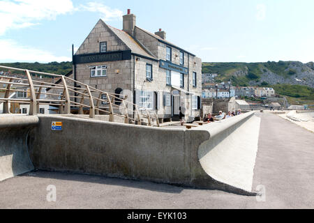 Wave return wall, The Cove House Inn historic building at Chiswell, Isle of Portland, Dorset, England, UK Stock Photo