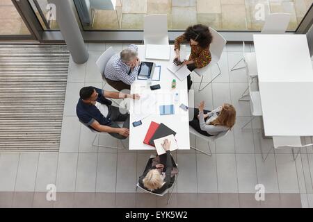 Overhead view of business team having meeting at conference table