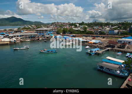 Boats, coastal water and part of the coastal landscape of Manado City in North Sulawesi, Indonesia. Stock Photo