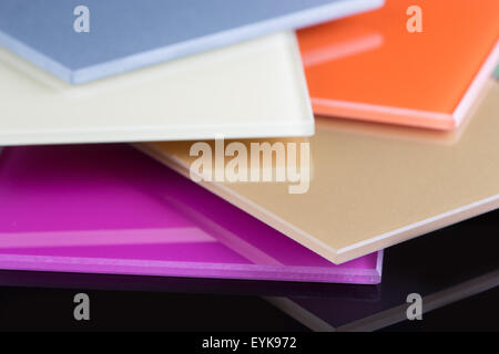 a stack of colored glass on a black background. glass sheets Stock Photo