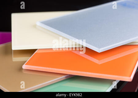 a stack of colored glass on a black background. glass sheets Stock Photo