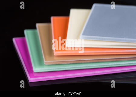 a stack of colored glass on a black background. glass sheets Stock Photo