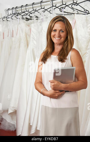 Portrait Of Female Bridal Store Owner With Digital Tablet Stock Photo