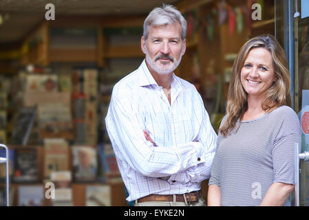 Portrait Of Couple Who Own Bookshop Outside Store Stock Photo