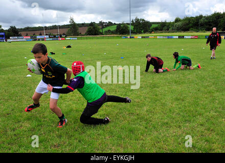 Children playing rugby at a summer camp in Londonderry (Derry), Northern Ireland Stock Photo