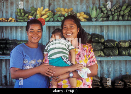 Chuuk, Micronesia: women and baby in roadside produce stand on Weno Island (Marinta Hater, Cathy Andeneas, Even Boy). Stock Photo