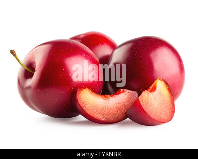 Three plums with slices isolated on white background Stock Photo