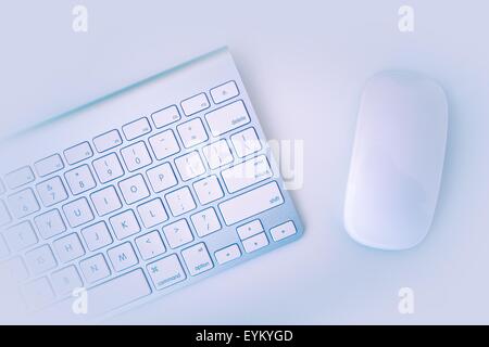 White Computer Keyboard and Mouse on the White Table. Stock Photo