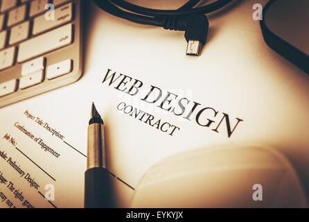 Web Design Contract Documents to Sign and Desk Equipment Around. Web Design Business Concept. Stock Photo