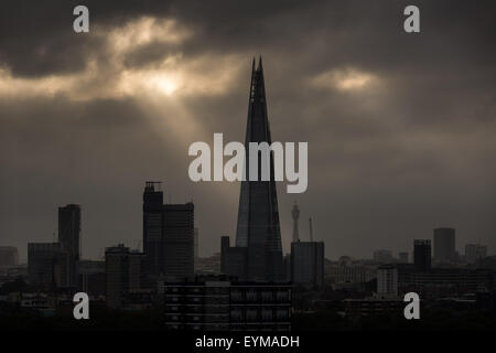 Evening light rays over London city landscape with The Shard Building in prominent view Stock Photo