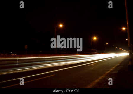 A long exposure of traffic which are going through road. Stock Photo