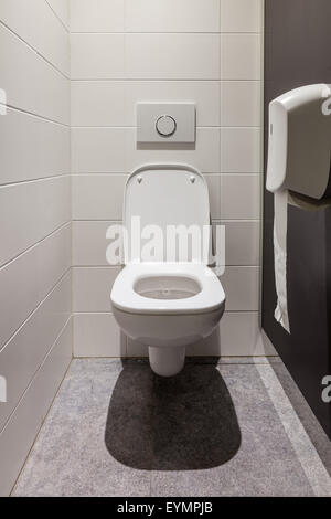 Modern men's restroom with white porcelain urinals in line Stock Photo ...