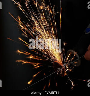 Sparks while sawing metal. close up Stock Photo