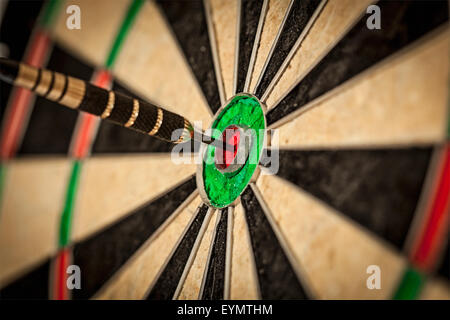 Success hitting target aim goal achievement concept background - dart in bull's eye close up Stock Photo