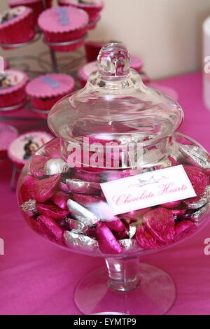 Chocolate Hearts in a glass jar on a dessert table at a party Stock Photo