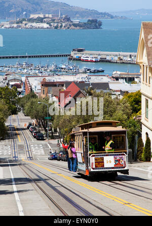 A Cable Car Going down Hyde Street in Downtown San Francisco, USA Stock Photo