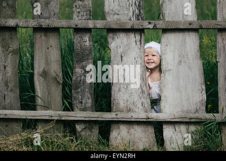 little girl and wooden fence Stock Photo