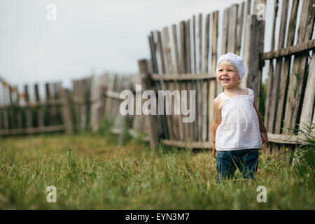 little girl and wooden fence Stock Photo