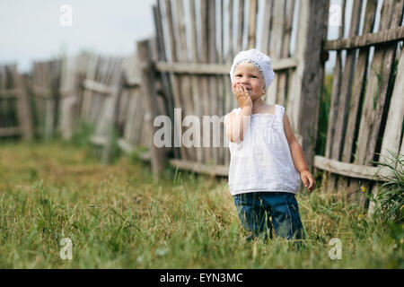 little girl and wooden fence Stock Photo