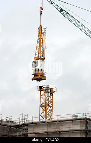 Construction workers dismantling tower crane Stock Photo