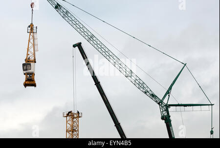 Construction workers dismantling tower crane Stock Photo