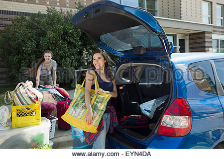 College students unloading car moving into college dorm