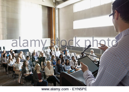 Professor speaking at podium to auditorium audience Stock Photo ...