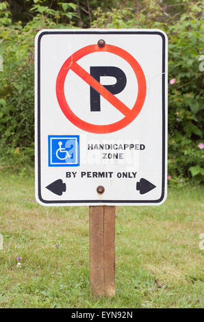No parking in handicapped zone sign. Sign on grass area. Stock Photo