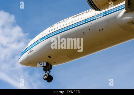 Kuwait Airways Boeing 777 aeroplane passes low overhead on approach to land Stock Photo