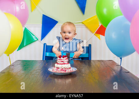 Super cute baby blowing her first birthday candle Stock Photo