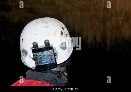 Speleologist exploring a limestone cave in Basque Country. Spain. Stock Photo