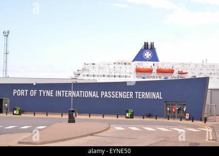 Port of Tyne International Passenger Terminal sign, with DFDS seaways ferry behind, Newcastle, England, UK Stock Photo