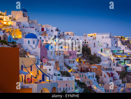 Iconic sunset in the town of Oia on the greek island Santorini (Thera). Stock Photo