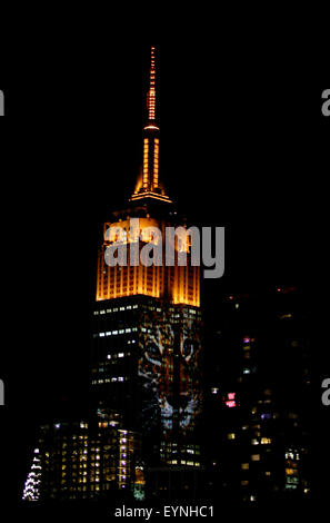 New York City, USA. 1st Aug, 2015. Digital images of endangered species are projected onto the south face of New York City's Empire State Building on Saturday evening.  The project, entitled #racingextinction, is the brainchild of filmmaker and photographer Louis Psihoyos and multimedia artist Travis Threlkel, and is designed to raise awareness of the plight of threatened creatures.  The collaborators refer to it as a 'weapon of mass instruction.'  The images were projected using 40 projectors of 20,000 lumens each. Credit:  Adam Stoltman/Alamy Live News Stock Photo