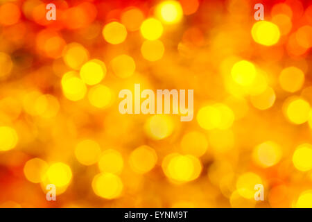 abstract blurred background - yellow and red twinkling Xmas lights of garlands on Christmas tree Stock Photo